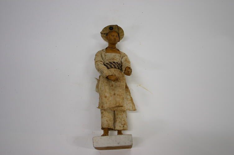 Small clay figure of a man wearing belt made of rope.