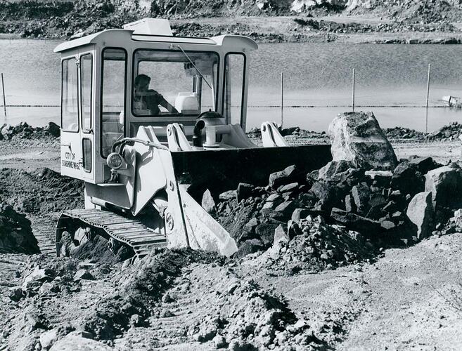 Crawler loader in rock quarry.