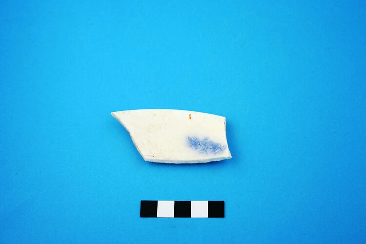 Fragment of porcelain saucer rim.