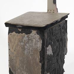 Fire damaged off-white painted wooden box with flap lid, charred black on one side.
