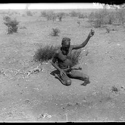 A Warumungu man making hair string with a spindle, Tennant Creek, 22 August 1901.