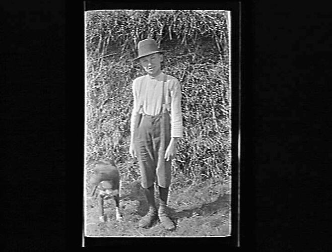 Photograph of a boy and dog