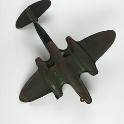 Dark green metal toy aeroplane. Underside view.