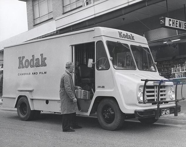 Photograph - Kodak Australasia Pty Ltd, Man Putting Kodak Parcel in Kodak Delivery Van Parked Outside Chemist, Melbourne, circa 1965