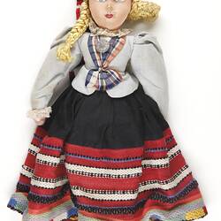 National Doll - Female with Black Skirt & Striped Woven Trim, Displaced Persons' Camp Craft, Germany, circa 1945-1951