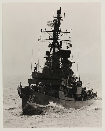 Naval ship in water, in black and white.
