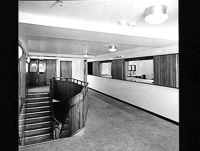 Ship interior. Double sided descent staircase at left. Walkway at right. Office at side and rear.