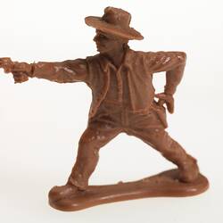 Brown plastic cowboy pointing a gun.