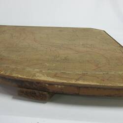 Quadrant of wood with printed and drawn map,  side view.