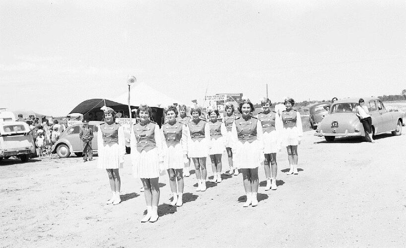 Monochrome photograph of a marching band.