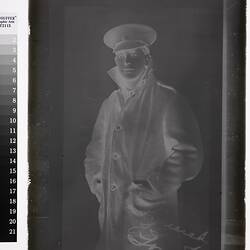 Studio portrait of man in coat and military cap.