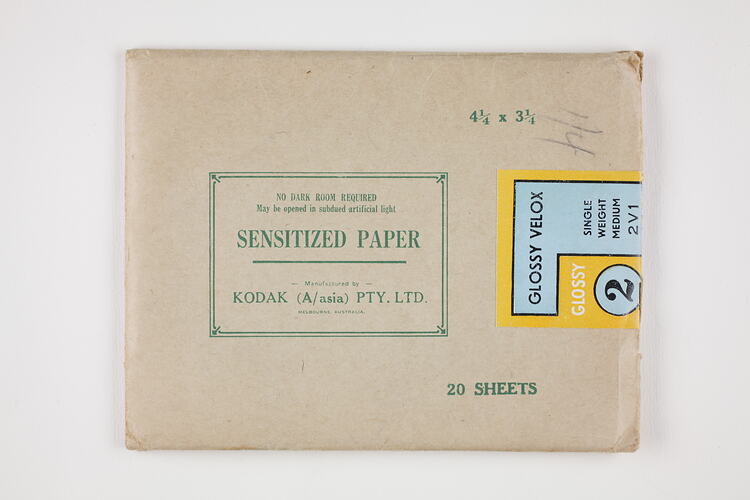 Brown paper packet sealed with printed label.