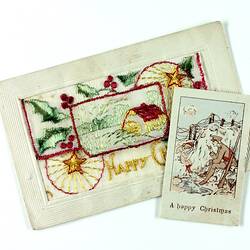Embroidered postcard with small card on top.