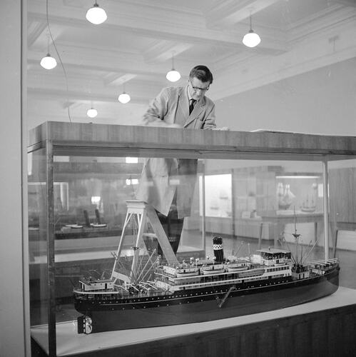 Staff member attending to shipping display at the Institute of Applied Science (Science Museum), Melbourne, 1968