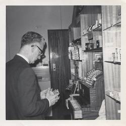 Photograph - Ron Williamson at Cash Register, Kodak Staff Shop, Coburg, circa 1960s