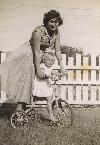 Eileen & Susan Leech Riding Her Tricycle in Back Yard, Frankston, circa 1954