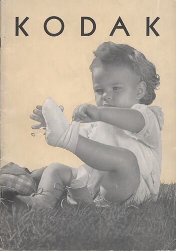 Cover page with photograph of baby removing sock.
