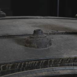 Black wooden hearse, detail of decorative woodwork. Base where urn once was.