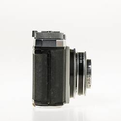 Chrome metal and black leather viewfinder camera. Right profile.