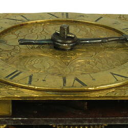 Decorative table clock, square gilded brass case. Detail of face.
