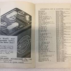 Open catalogue with printed image on left of car battery advertisement. Text on right.
