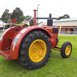Right side view of tractor parked on arena.