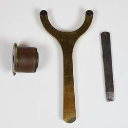 Three metal parts of instrument.
