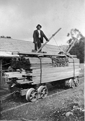 [Loading milled timber onto a rail truck, Colac, circa 1925.]