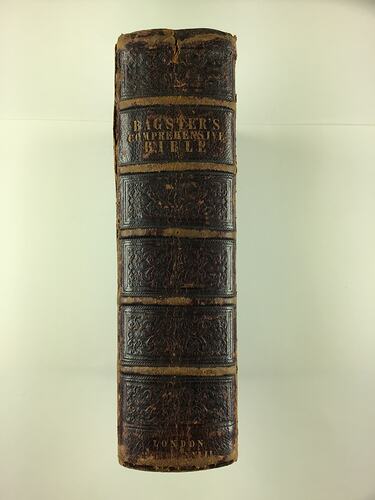 Spine of bible with brown leather binding.