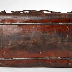 Worn brown leather suitcase.