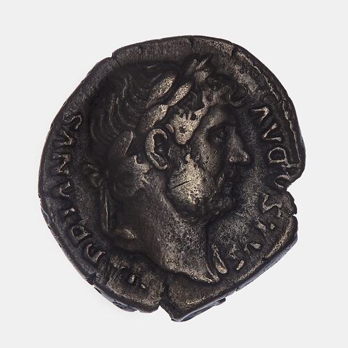 Roughly round coin with wreathed male head facing right. Text around.