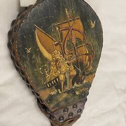 Painted ship on wooden bellows.