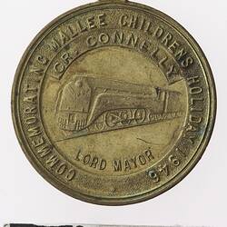 Round medal with train and text surrounding.