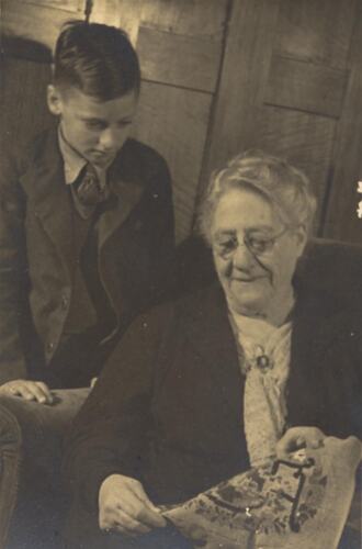 Digital Photograph - Postcard, Boy with Grandmother in Lounge room, St Kilda, circa 1943