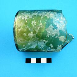 Green glass bottle base and partial body.