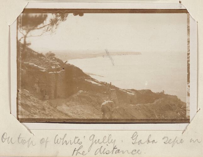 Serviceman in trenches with cove in the background.