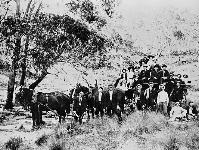 Picnic group travelling in a horsedrawn wagon.