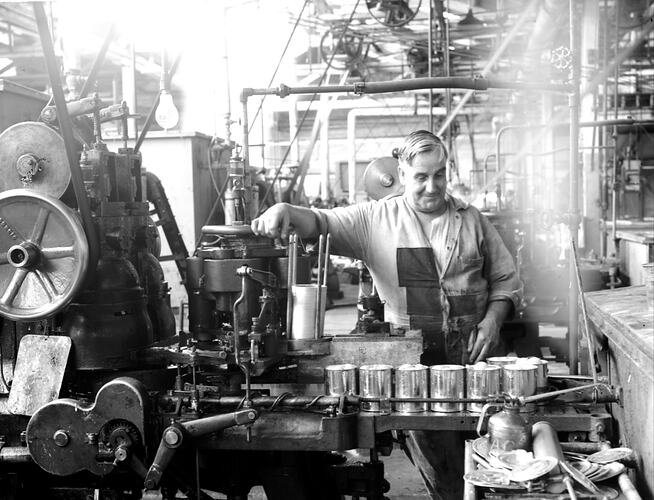 [Crimping cans at the Ardmona Fruit Packing Company, Mooroopna, January 1946.]