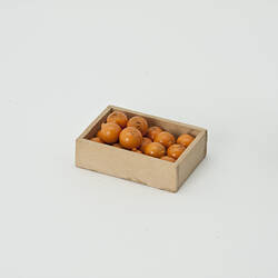 Wooden box filled with oranges.