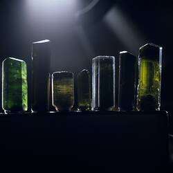 Seven rectangular mineral specimens in a row.