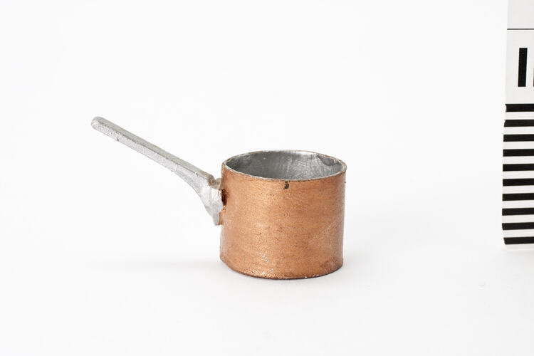 Tiny saucepan, copper with silver handle.