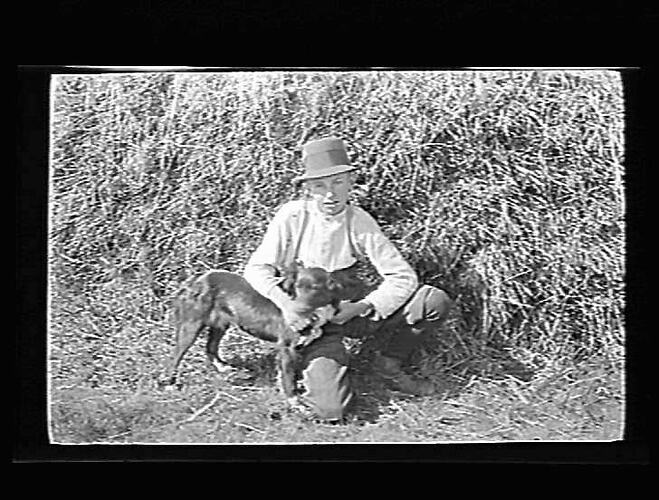 Boy wearing a hat with dog.