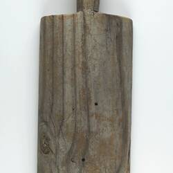 Front of worn, wooden paddle-shaped bat.