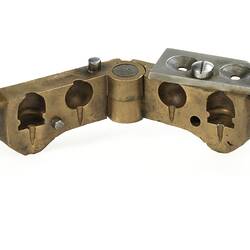 Open hand-held brass bullet mould.