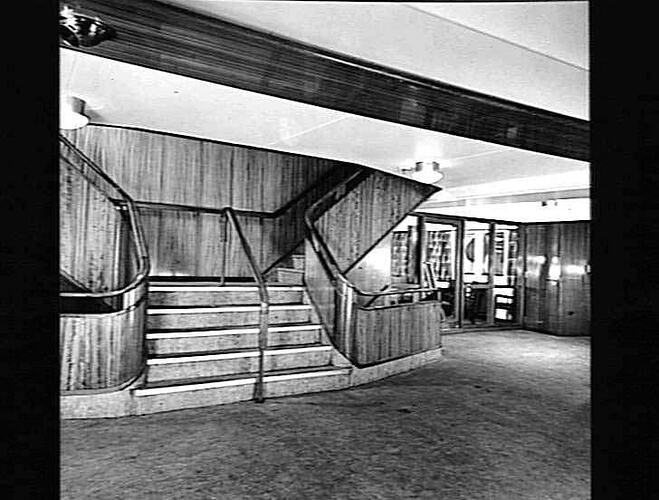 Ship interior. Double sided staircase, walkway at right. Office at rear.