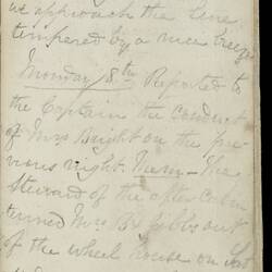Open diary with handwritten text on discoloured worn page.