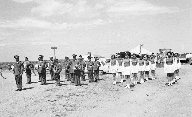 Monochrome photograph of a marching band.