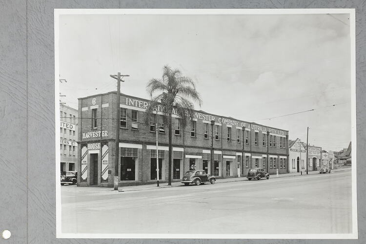 Monochrome photograph of a showroom exterior.