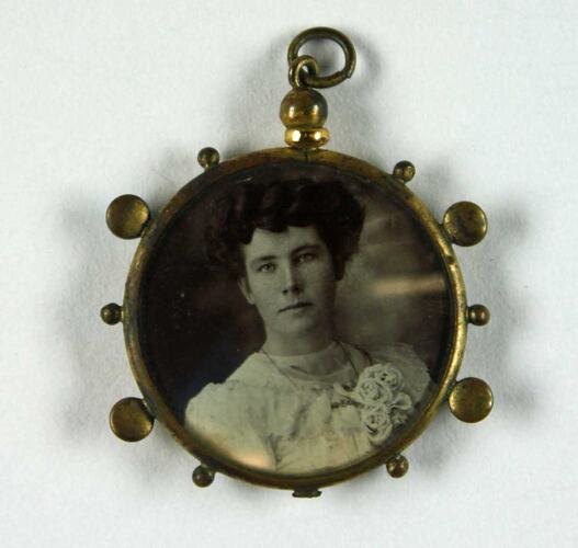 Pendant with photo showing woman's upper body.