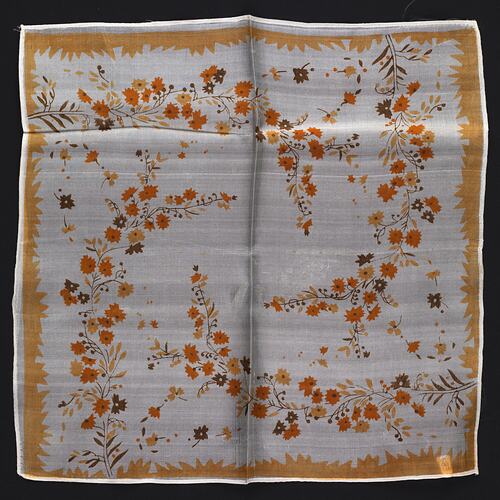 Cream silk handkerchief with orange flowers.